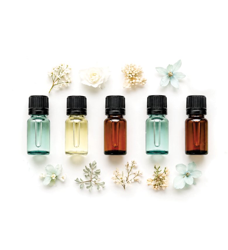 Essential oil bottles and flowers used in the perfume workshop